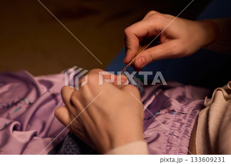 Crochet workshop scene, Artisan at work with yarn, Cozy crafting space with textured handmade stitches, Quiet studio environment dedicated to knitting and crochet crafts today Crochet workshop scene, Artisan at work with yarn, Cozy crafting space with textured handmade stitches, Quiet studio environment dedicated to knitting and crochet crafts today 133609231