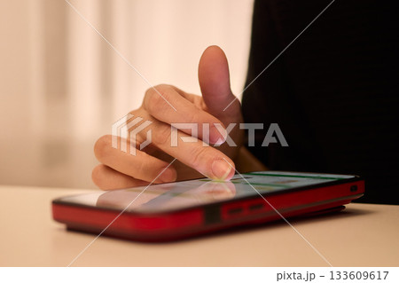 Nightly hand gestures on smartphone, Fingers tapping and engaging with phone during night hours, Closeup shot capturing hand movements interacting with mobile device at night 133609617