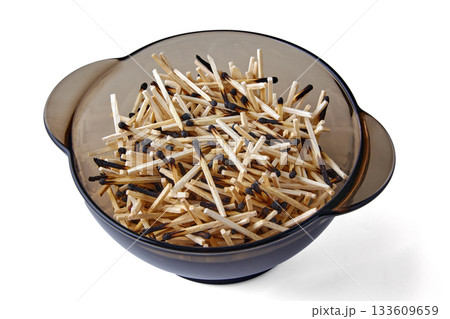 Burnt wooden matches in a glass bowl isolated on white background. 133609659