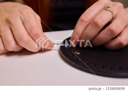 Crochet workshop scene, Artisan at work with yarn, Cozy crafting space with textured handmade stitches, Quiet studio environment dedicated to knitting and crochet crafts today 133609899