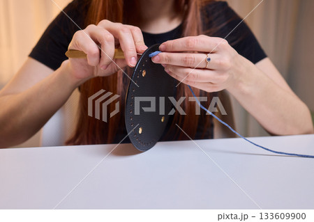 Crochet workshop scene, Artisan at work with yarn, Cozy crafting space with textured handmade stitches, Quiet studio environment dedicated to knitting and crochet crafts today 133609900