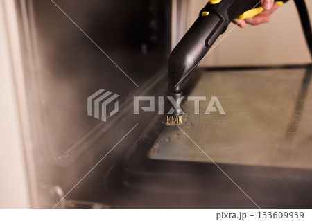 Steam tool purges baked grease, Focused steam device eliminates stubborn oven grime, Precise steam cleaning process handles tough residue from oven glass door effectively 133609939