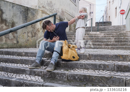 A Father Having a Health Problem and His Little Daughter Trying to Help A Father Having a Health Problem and His Little Daughter Trying to Help 133610216