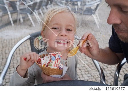 Girl Eating Ice Cream with Her Dad at a Cafe 133610277