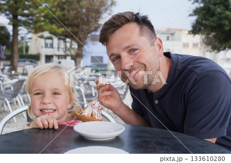 Girl Eating Ice Cream with Her Dad at a Cafe Girl Eating Ice Cream with Her Dad at a Cafe 133610280