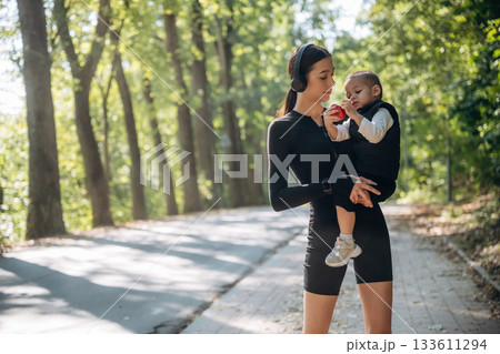 Mother with her little son is outdoors. In sportive clothes 133611294