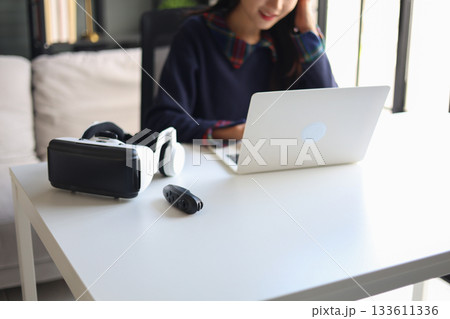 Women working with laptop and VR headsets. Women working with laptop and VR headsets. 133611336