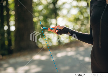 Close up view of woman with jump rope outdoors 133611360