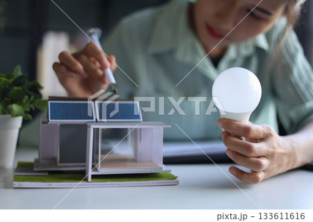 Beautiful engineer working in office design eco friendly and sustainable living home. Beautiful engineer working in office design eco friendly and sustainable living home. 133611616