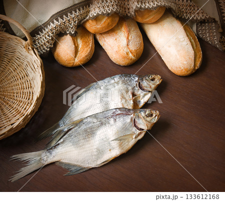 Bread and fish on the table 133612168
