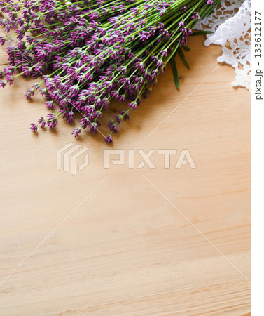Lavender flowers lie on the table on lace Lavender flowers lie on the table on lace 133612177