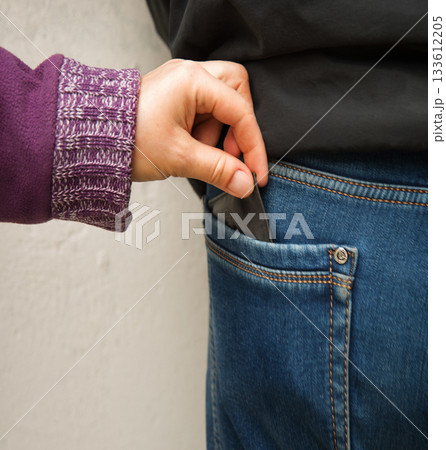 A hand takes money 133612205