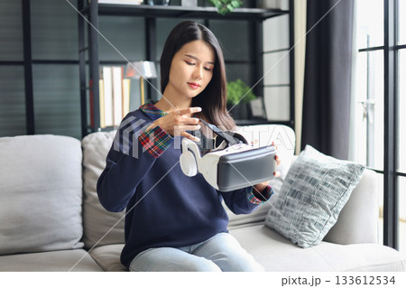 Young asian woman wearing virtual reality glasses. VR headset. VR concept. 133612534