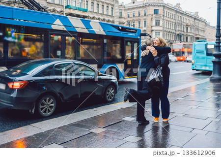 Two female friends met and joyfully hugged each other 133612906