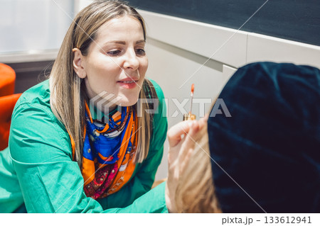 Two beautiful women met in a cafe and started talking and discussing cosmetics Two beautiful women met in a cafe and started talking and discussing cosmetics 133612941