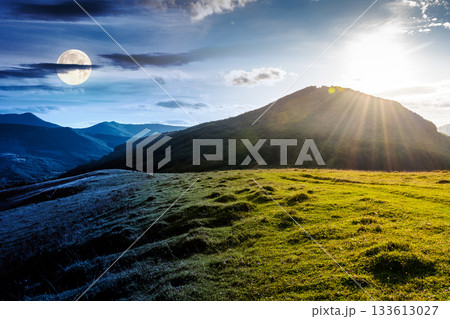 beautiful countryside. day and night time change concept. scenic view of grassy field and rolling hills. wonderful summertime landscape in mountains with sun and moon. duality and transition template 133613027