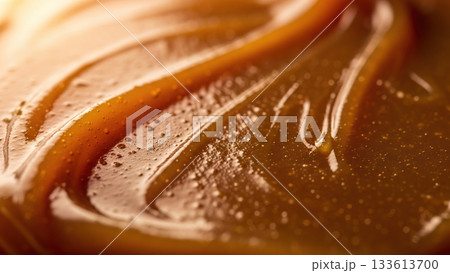 Delicious caramel swirl texture with golden light for dessert background 133613700