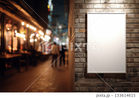 Empty framed poster on a brick wall with blurred urban alley background. 133614615