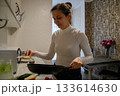Daily Kitchen Routine at Home. Real Life Moments of a Young Woman 133614630