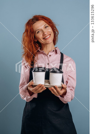 Waitress is with drinks. Woman is in the studio against background Waitress is with drinks. Woman is in the studio against background 133615296