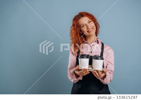 Waitress is with drinks. Woman is in the studio against background Waitress is with drinks. Woman is in the studio against background 133615297