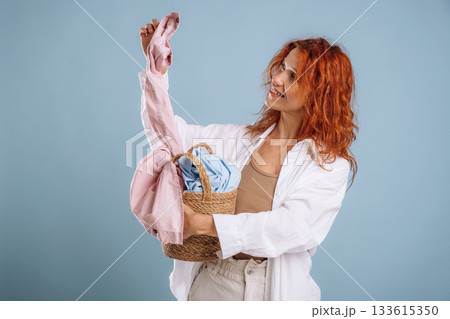 Clothes are not dirty anymore, washed. Woman is in the studio against background 133615350