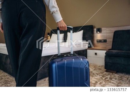 Close up view of maid with suitcase in the hotel room Close up view of maid with suitcase in the hotel room 133615757