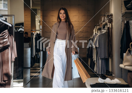 Happy facial expression. Woman chooses clothes in retail store 133616121