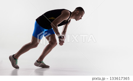 Runner bending forward and checking smartwatch after effort. Runner bending forward and checking smartwatch after effort. 133617365