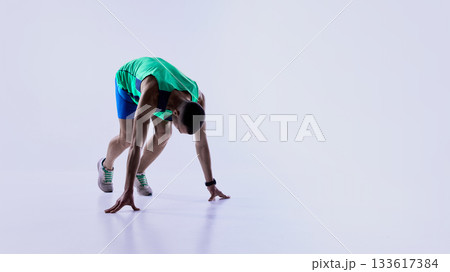 Runner accelerating into fast forward stride 133617384