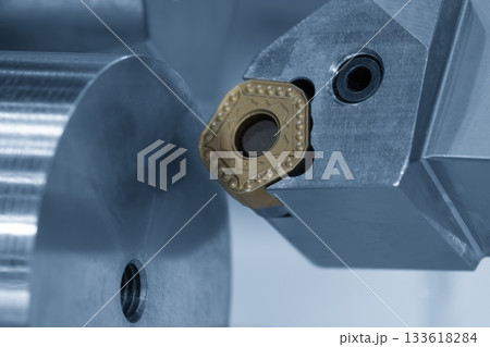Close up scene the chip insert tool for CNC lathe machine in the light blue scene. 133618284