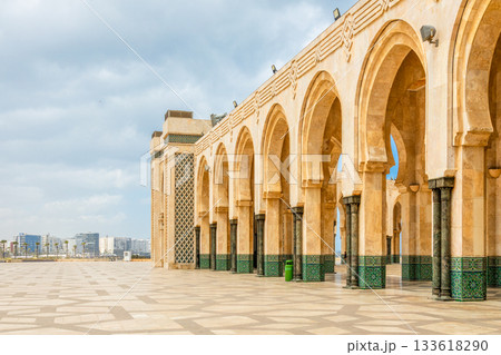 Wide square and exterior arches with carved stone columns and traditional tilework at the Hassan II Mosque, Casablanca, Morocco Wide square and exterior arches with carved stone columns and traditional tilework at the Hassan II Mosque, Casablanca, Morocco 133618290