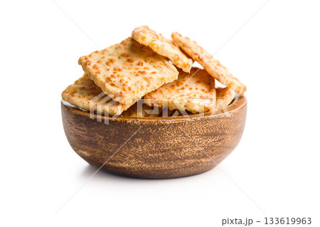 Crunchy salted crackers in bowl  isolated on white background. 133619963