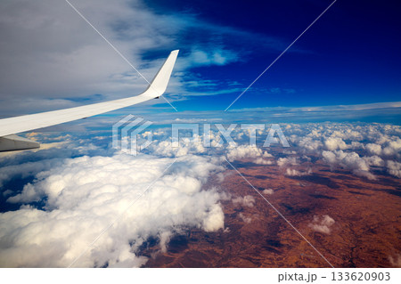 Aircraft wing in a cloudy stormy clouds sky Aircraft wing in a cloudy stormy clouds sky 133620903