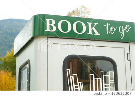 Book to go. Public street book-sharing kiosk with free community books for readers 133621307