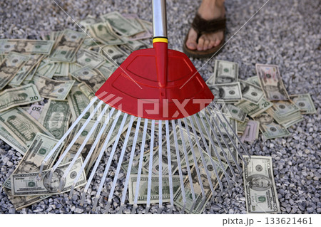 Cleaning black dolar money with rake, metaphor 133621461