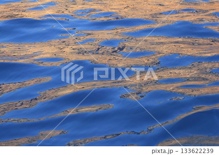 Abstract golden reflection blue water shapes Abstract golden reflection blue water shapes 133622239