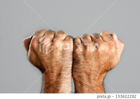 Hairy man fist closeup expression over gray Hairy man fist closeup expression over gray 133622282