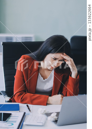 tired business woman sleepy and bored from sitting at a desk for a long time and has office syndrome 133622664