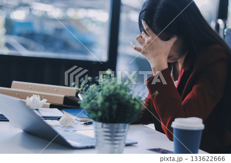 tired business woman sleepy and bored from sitting at a desk for a long time and has office syndrome 133622666