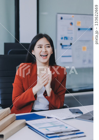 Asian business woman working on a laptop in a professional office Asian business woman working on a laptop in a professional office 133622669