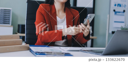 Asian business woman working on a laptop in a professional office 133622670