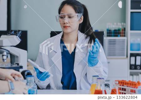 Portrait, science and happy woman on laptop in lab to research chemistry, test or innovation. Microscope, scientist and face of medical doctor in goggles for microbiology, healthcare or pharma study 133622804