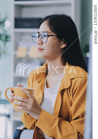 Business woman using calculator for do math finance on wooden desk in office and business working background, tax, accounting, statistics and analytic research concept. 133622805