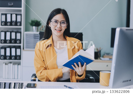 Business woman using calculator for do math finance on wooden desk in office and business working background, tax, accounting, statistics and analytic research concept. 133622806