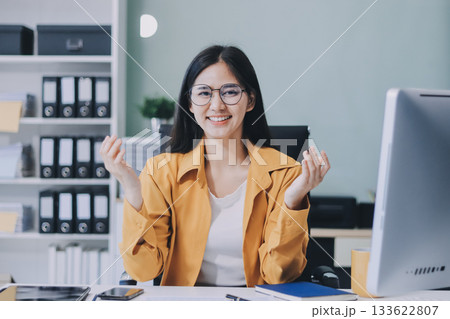 Business woman using calculator for do math finance on wooden desk in office and business working background, tax, accounting, statistics and analytic research concept. Business woman using calculator for do math finance on wooden desk in office and business working background, tax, accounting, statistics and analytic research concept. 133622807