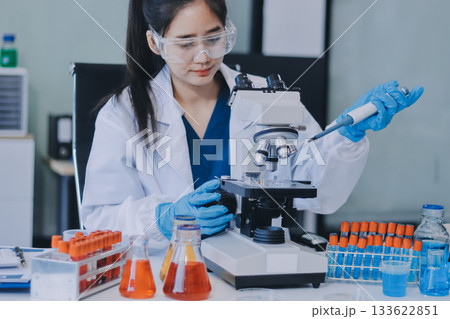 Portrait, science and happy woman on laptop in lab to research chemistry, test or innovation. Microscope, scientist and face of medical doctor in goggles for microbiology, healthcare or pharma study Portrait, science and happy woman on laptop in lab to research chemistry, test or innovation. Microscope, scientist and face of medical doctor in goggles for microbiology, healthcare or pharma study 133622851