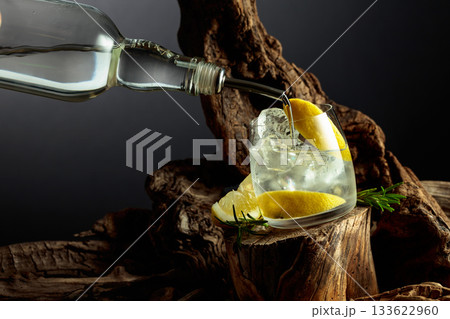 Cocktail gin and tonic with lemon slices and sprig of rosemary. 133622960