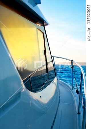 blue golden sunrise sailing on boat side 133623065