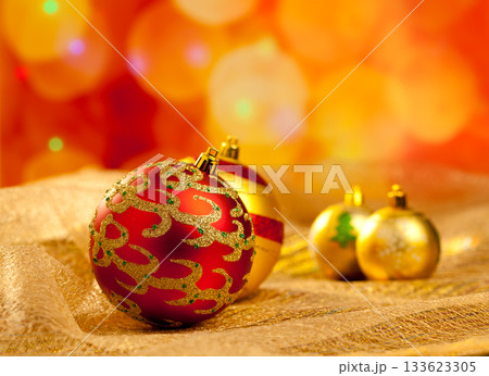 Christmas golden and red baubles in blur lights 133623305